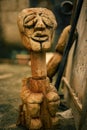 Vertical closeup shot of a wooden carving of doll at Knust, Kumasi, Ghana