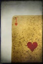 Vertical closeup shot of a worn-out playing card of hearts - perfect for background