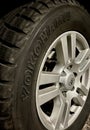 Vertical closeup shot of a Yokohama winter tire on a Toyota Land Cruiser