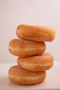 Vertical closeup of a stack of donuts served on a white background Royalty Free Stock Photo