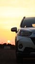 Vertical closeup of Toyota Rush with a golden and purple sunset sky background