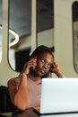 Vertical closeup unhappy multiethnic business woman talk phone. Bad news. Remote working on laptop in cafe, e-commerce Royalty Free Stock Photo