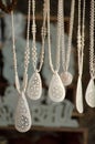 Vertical closeup view of white necklaces made of marble in a shop in Bhedaghat, India