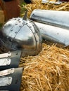 Vertical closeup of a Viking helmet and armors on the crafted paddy straw, blurred background