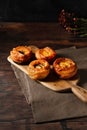 Vertical closeup of Vol-au-vent puff pastry on a cutting board on a wooden table