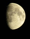 Vertical closeup of a Waxing Gibbous moon phase against a black background Royalty Free Stock Photo