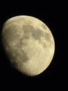 Vertical closeup of a Waxing Gibbous moon phase against a black background Royalty Free Stock Photo