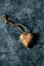 Vertical closeup of a wooden heart-shaped pendant of a  necklace Royalty Free Stock Photo