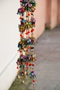 Vertical closuep shot of small souvenir elephants hanged on ropes with beads in the blurry street Royalty Free Stock Photo