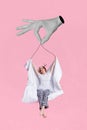 Vertical collage image of black white hand fingers hold strings hanging girl stretching blanket isolated on pink Royalty Free Stock Photo