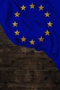 Vertical color European Union flag, symbol of united Europe, beautiful silk, background old wood, concept of tourism, economy,