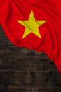 Vertical color national national flag of modern state of Vietnam, beautiful silk, background old wood, concept of tourism, economy