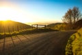 Gate entry to walking track beside metalled rural road with baton and wire fence, Mahia Peninsula, North Island, New Zealand Royalty Free Stock Photo