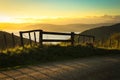 Gate entry to walking track beside metalled rural road with baton and wire fence, Mahia Peninsula, North Island, New Zealand Royalty Free Stock Photo