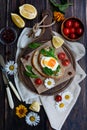 Vertical composition. Breakfast of a sandwich with egg, cheese and herbs, tomatoes on a dark wooden table. View from Royalty Free Stock Photo