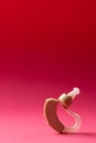 Vertical composition of hearing aid on red background with copy space Royalty Free Stock Photo