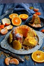 Vertical composition. Homemade muffin with chocolate chips, oranges and tangerines on a gray background