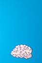 Vertical composition of white and purple brain on blue background with copy space