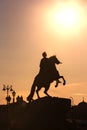 Vertical contrast silhouette of Bronze Horseman sculpture of Peter the Great on red orange sky and sun background