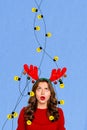 Vertical creative collage image of funny confused girl deer horns tangled garland decoration happy merry christmas new