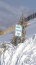 Vertical crop Building and Church Parking Only sign on the snowed in slope of Wasatch Mountain