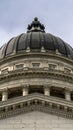 Vertical crop Dome and pediment of Utah State Capital building in Salt Lake City against sky