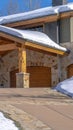 Vertical crop Home in Park City Utah with snowy gable roofs stone wall and outdoor stairs Royalty Free Stock Photo