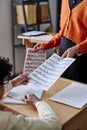 Unrecognizable Teacher Handing Out Sheet Music