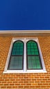 Vertical crop Sliding arched glas windows of a church in provo Utah against brick wall