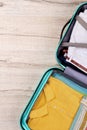 Vertical cropped image of packed suitcase. Royalty Free Stock Photo