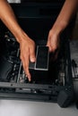 Vertical cropped shot of technician installing CPU water cooler into desktop computer case, showcasing process of Royalty Free Stock Photo