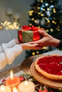 Vertical cropped shot of unrecognizable happy woman receiving Christmas gift from loving man at home on blurred Royalty Free Stock Photo