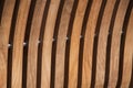 Vertical curved light colored wooden slat background.