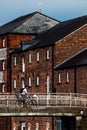 Vertical of a cyclist on a bridge in Newark on Trent town UK with brick buildings in the background