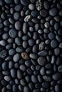 vertical dark pebbles texture background, closeup black smooth stones