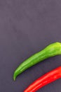 Vertical design black background couple of hot peppers part of a pod decoration design Royalty Free Stock Photo