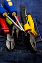 Vertical design tool engineer a pair of screwdrivers and tongs lies on a dark background