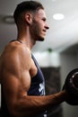 Vertical detail of a man`s arm performing biceps exercise in the gym Royalty Free Stock Photo