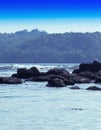 Vertical dramatic soft pale rocks in ocean horizon landscape bac Royalty Free Stock Photo