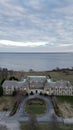 Vertical drone shot of the Aldrich Mansion on the coast of a sea in Warwick, Rhode island, USA Royalty Free Stock Photo