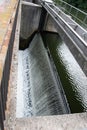 Vertical dutch angle shot of water flowing in a dam