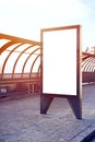 Vertical empty billboard placeholder template on the city bus stop, empty information banner template, space for mockup layout. Royalty Free Stock Photo