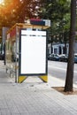 Vertical empty billboard placeholder template on the city bus stop, information banner template, space for mockup layout. Royalty Free Stock Photo