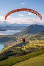 Vertical of an extreme sports lover paragliding in a picturesque landscape surrounding lake Annecy