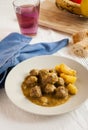 Moroccan kefta tajine meatballs on served on a table.