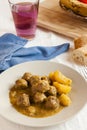 Moroccan kefta tajine meatballs on served on a table.