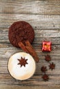 Vertical format Cappuccino and cookie with star ansie and cinnamon stick Jingle bell and gift