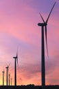 Vertical format of silhouettes of wind turbines on a farm in Iowa on a sunset sky