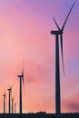 Vertical format of silhouettes of wind turbines on a farm in Iowa on a sunset sky