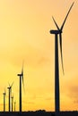 Vertical format of silhouettes of wind turbines on a farm in Iowa on a sunset sky